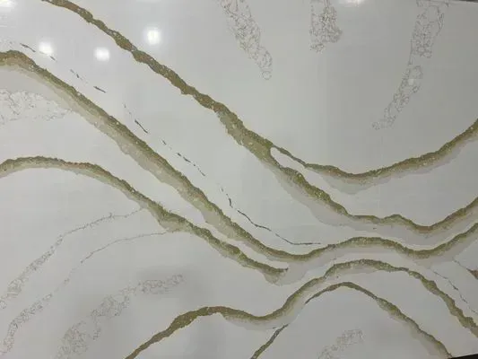 White countertop with gold veining, offering a luxurious aesthetic.