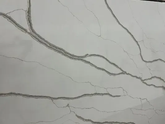 White countertop with grey veining, resembling marble.