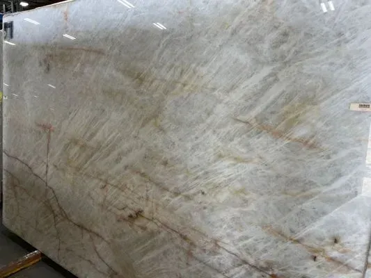 Large slab of creamy white marble with brown and tan veining.