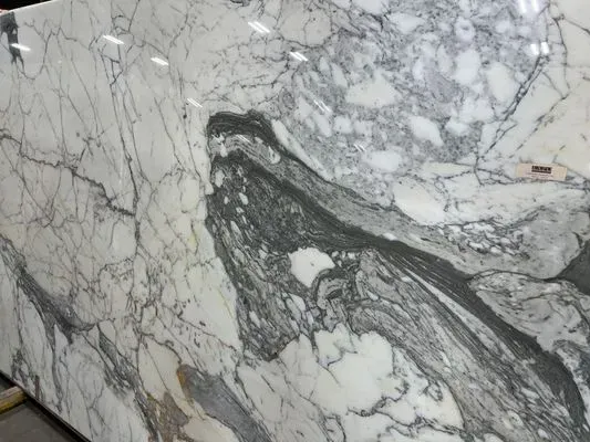 White marble slab with gray veining and swirls.