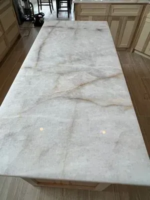 White marble countertop with brown veining in a kitchen.