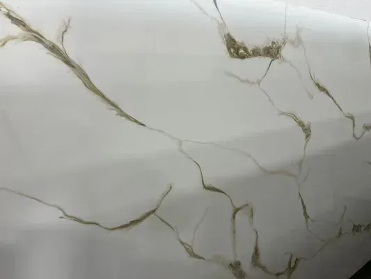White marble-patterned surface with brown veining.