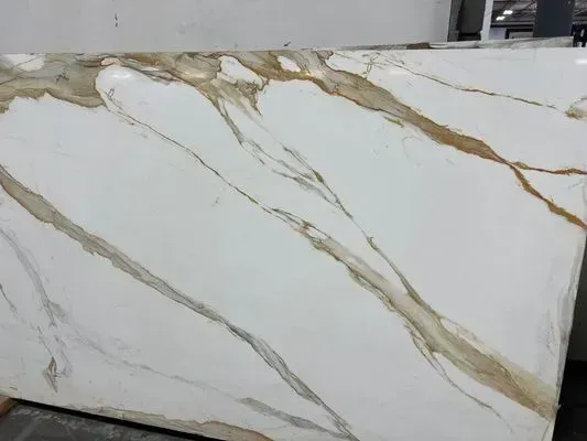 White marble slab with gold and brown veining.