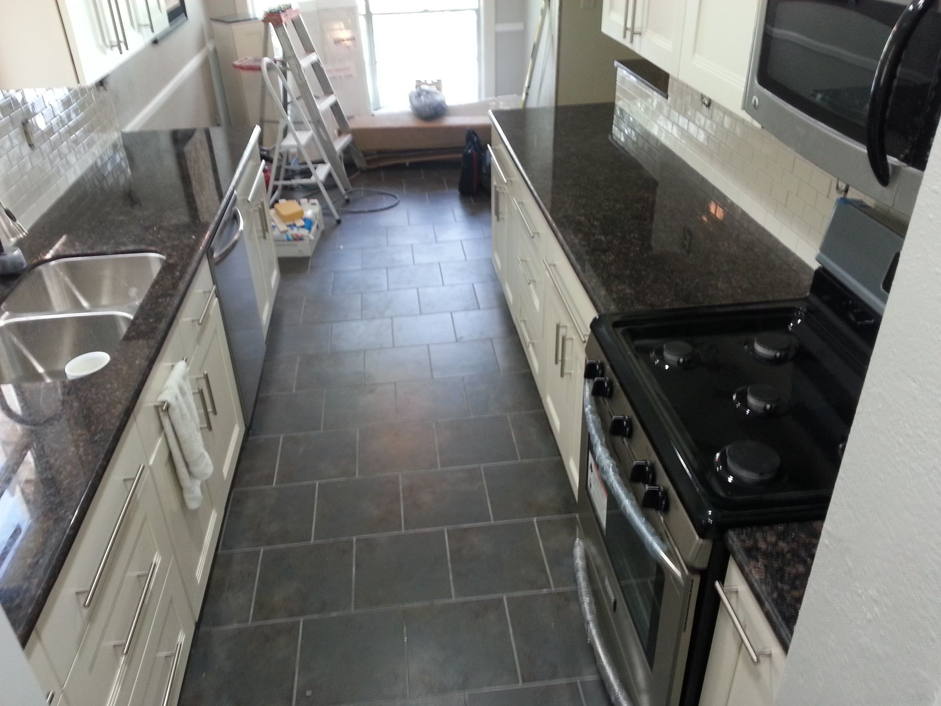 A living room with a couch , coffee table , and shelves.