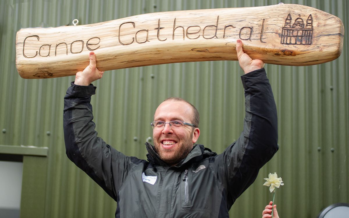 Chris Redmond with Canoe Cathedral sign