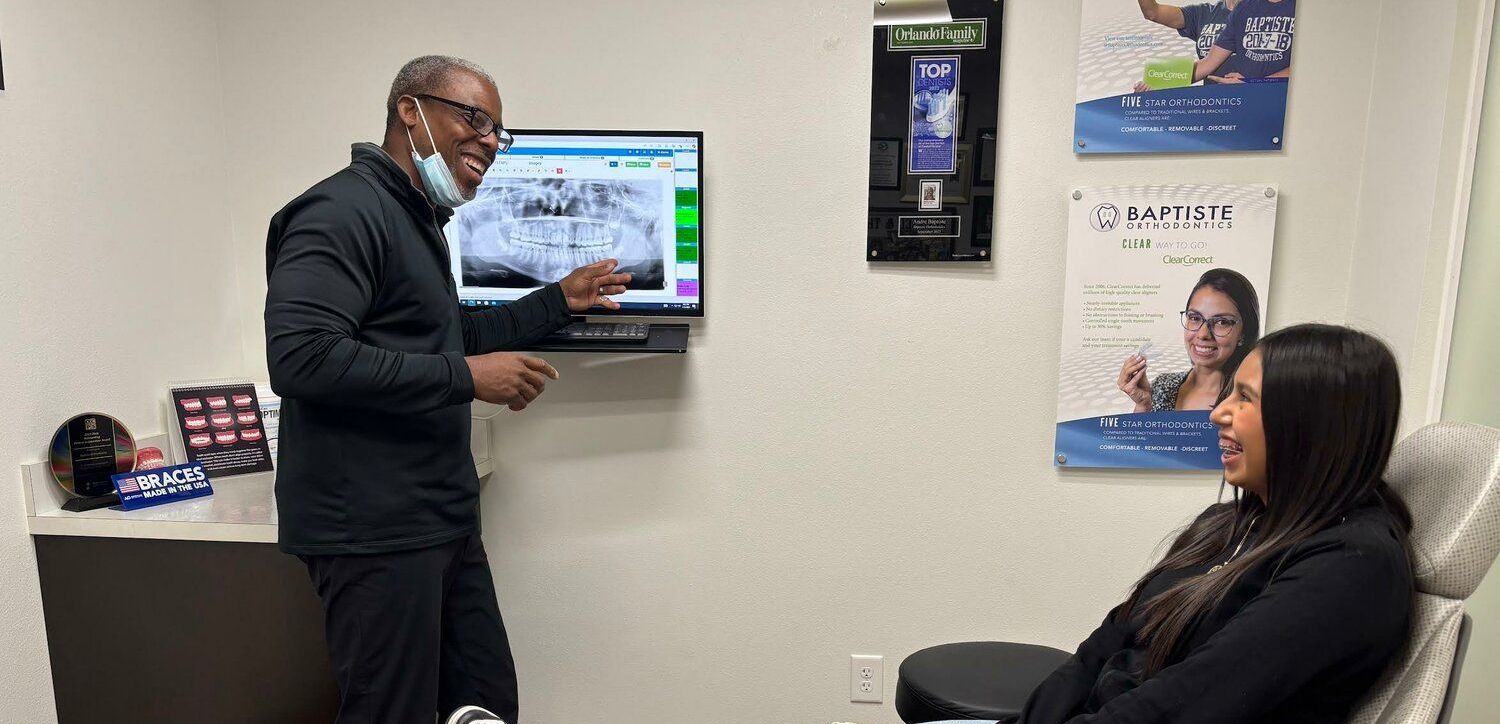 Dr. Andre Baptiste discusses wisdom teeth with a patient.