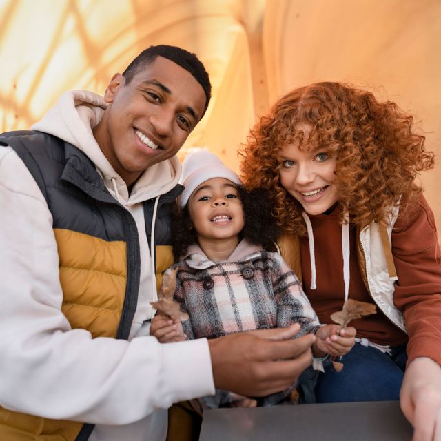 A man , woman and child are posing for a picture.