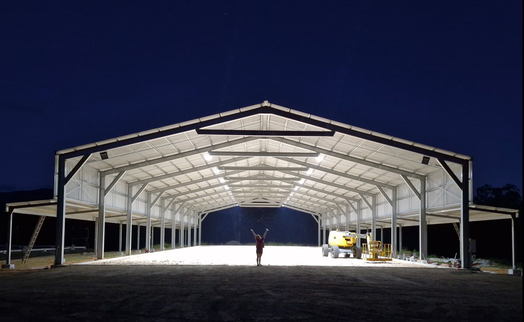A White Metal Building With a Black Roof and a White Door — Premier Building QLD In Speewah, QLD