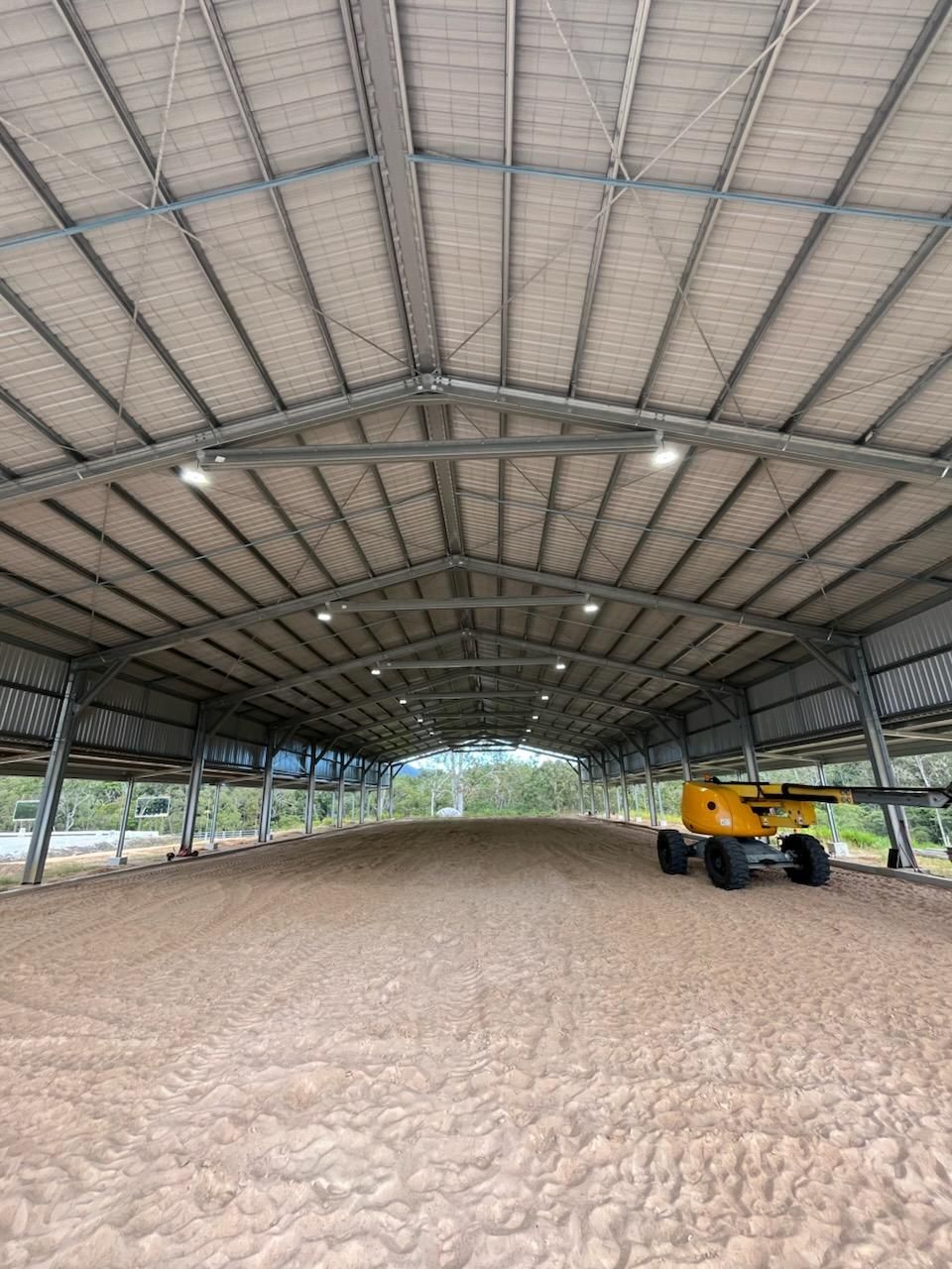 A Man in a Red Hat is Working on a Wooden Structure — Premier Building QLD In Speewah, QLD
