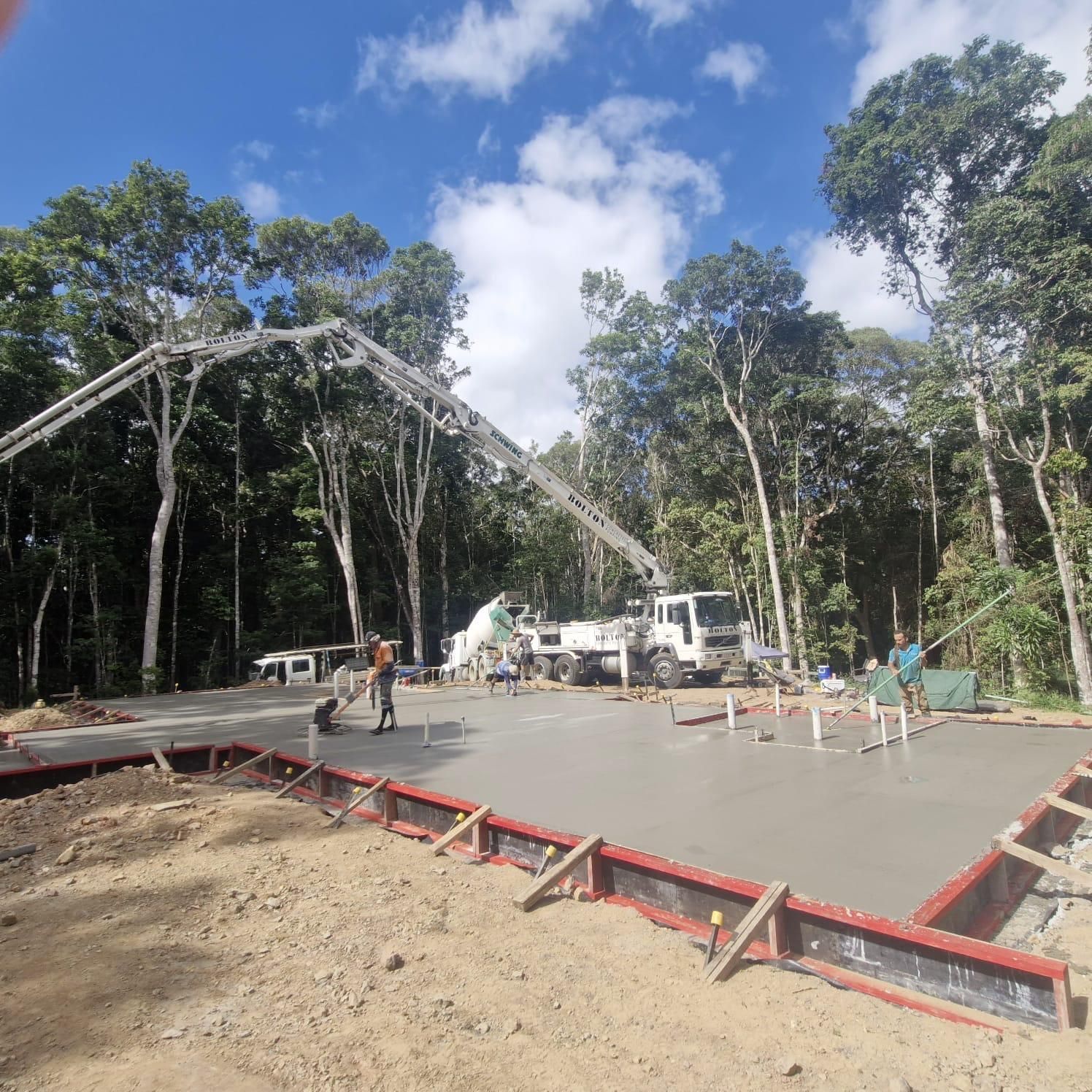 Two Men Are Working on the Roof of a Brick Building — Premier Inspections FNQ In Tablelands, QLD