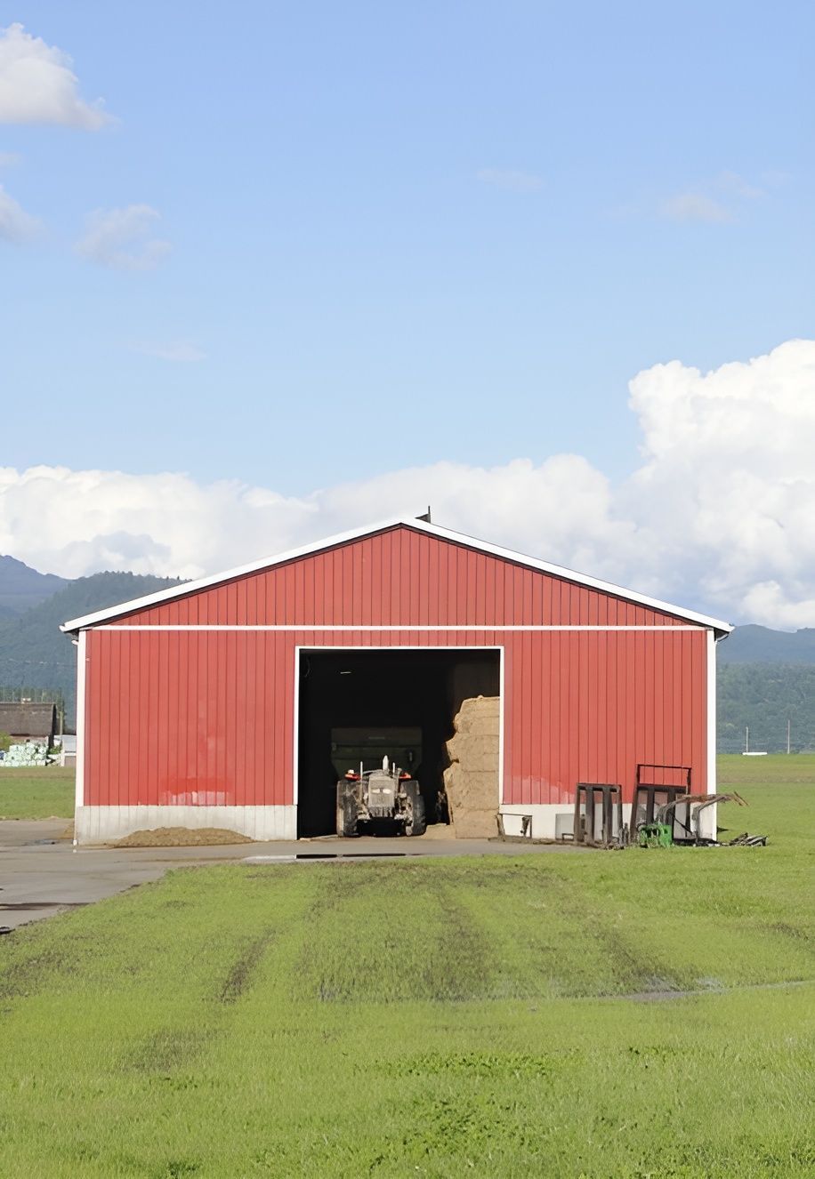 A Red Barn With a Tractor Inside of It — Premier Inspections FNQ In Cairns, QLD