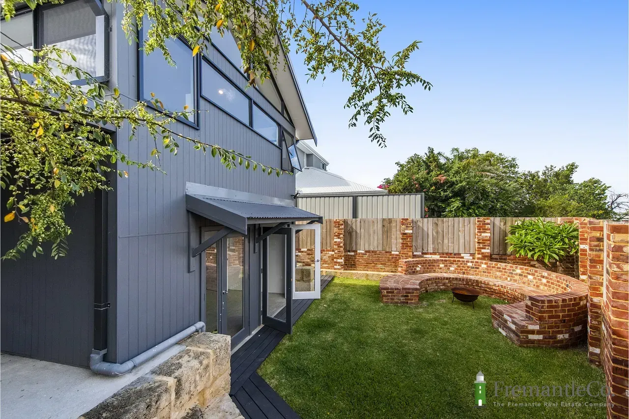 A Person is Holding a Piece of Tile on a Wall — Premier Building QLD In Speewah, QLD