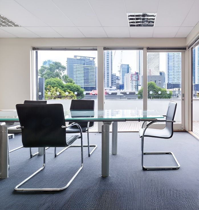 A Conference Room With a Glass Table and Chairs — Premier Building QLD In Speewah, QLD