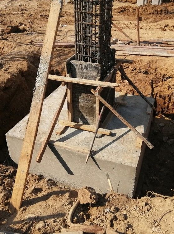 A Construction Site With a Concrete Block and Wooden Scaffolding — Premier Inspections FNQ In Speewah, QLD
