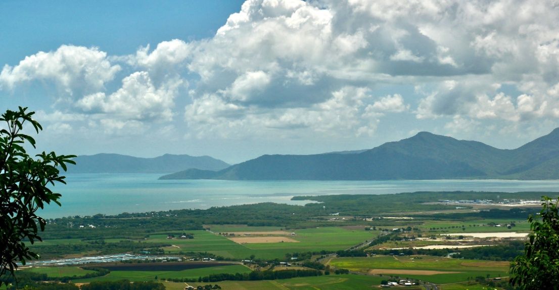 A View of a Large Body of Water With Mountains in the Background — Premier Inspections FNQ In Tablelands, QLD