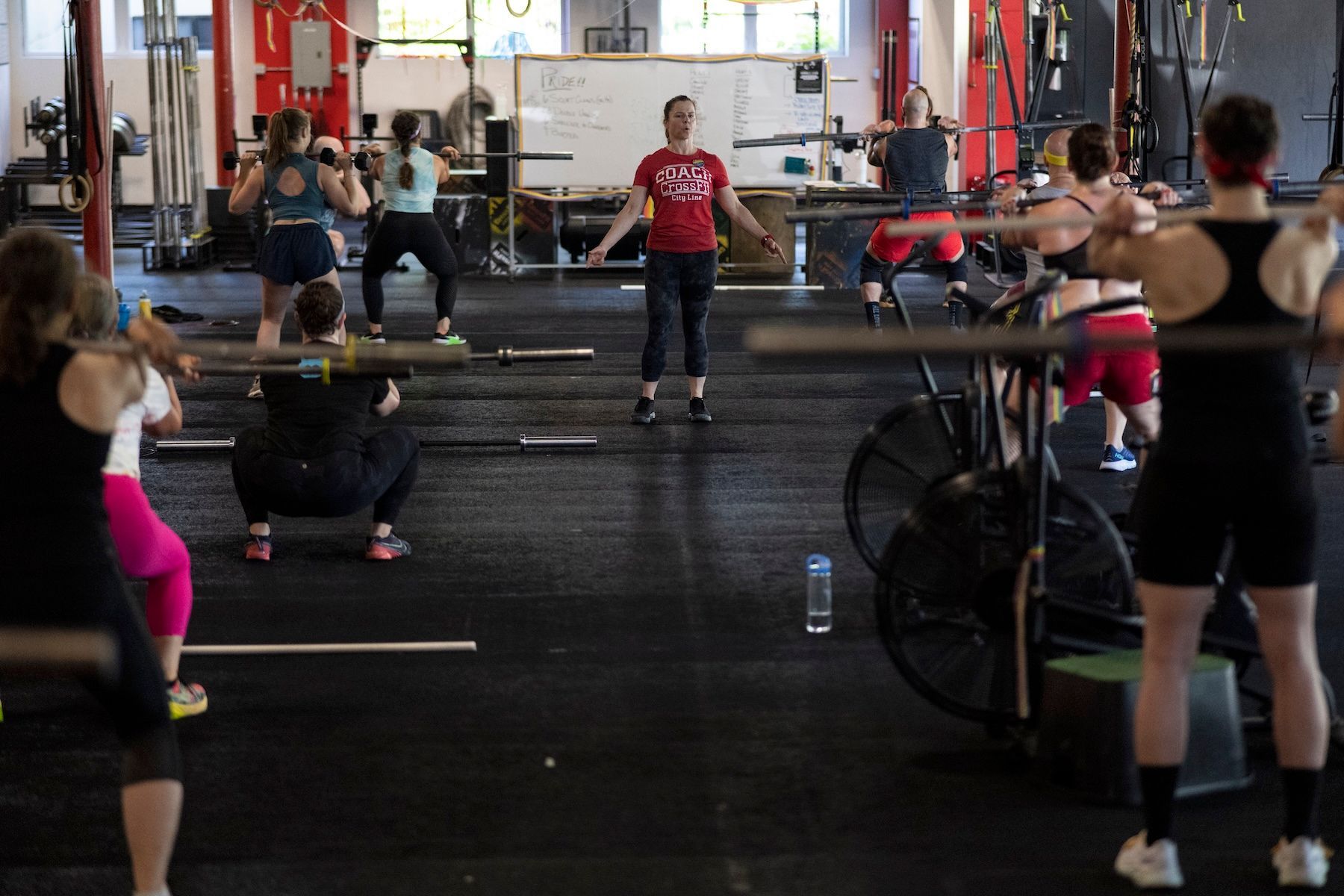 A group of people are doing exercises in a gym.