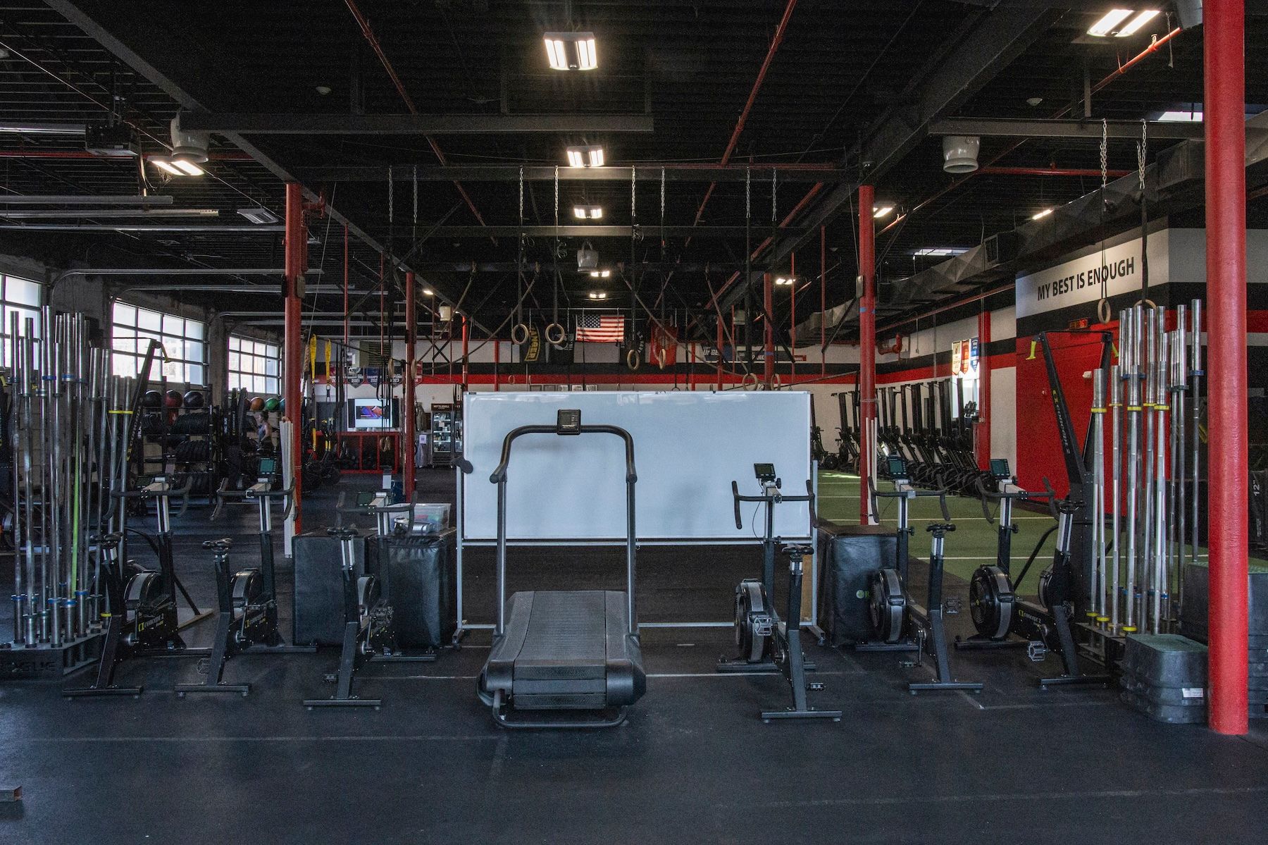 There is a treadmill in the middle of the gym.