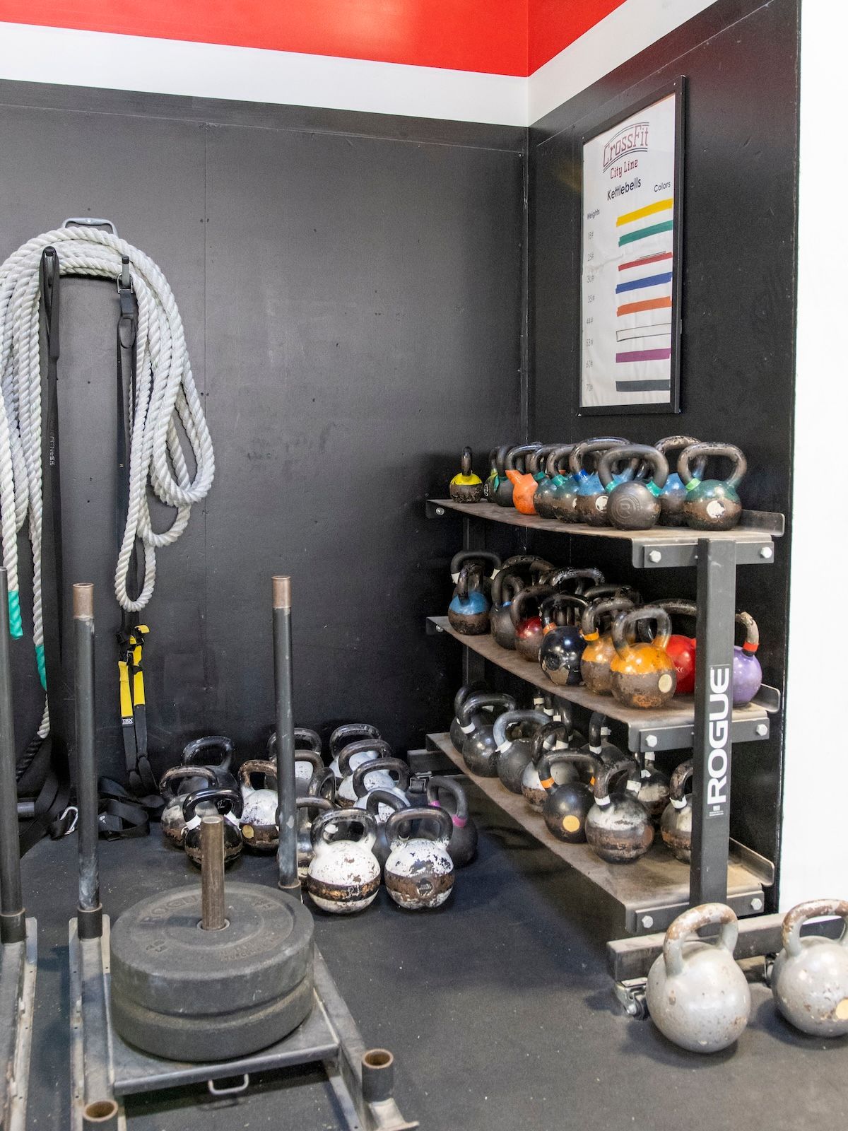 A room filled with lots of kettlebells and ropes.