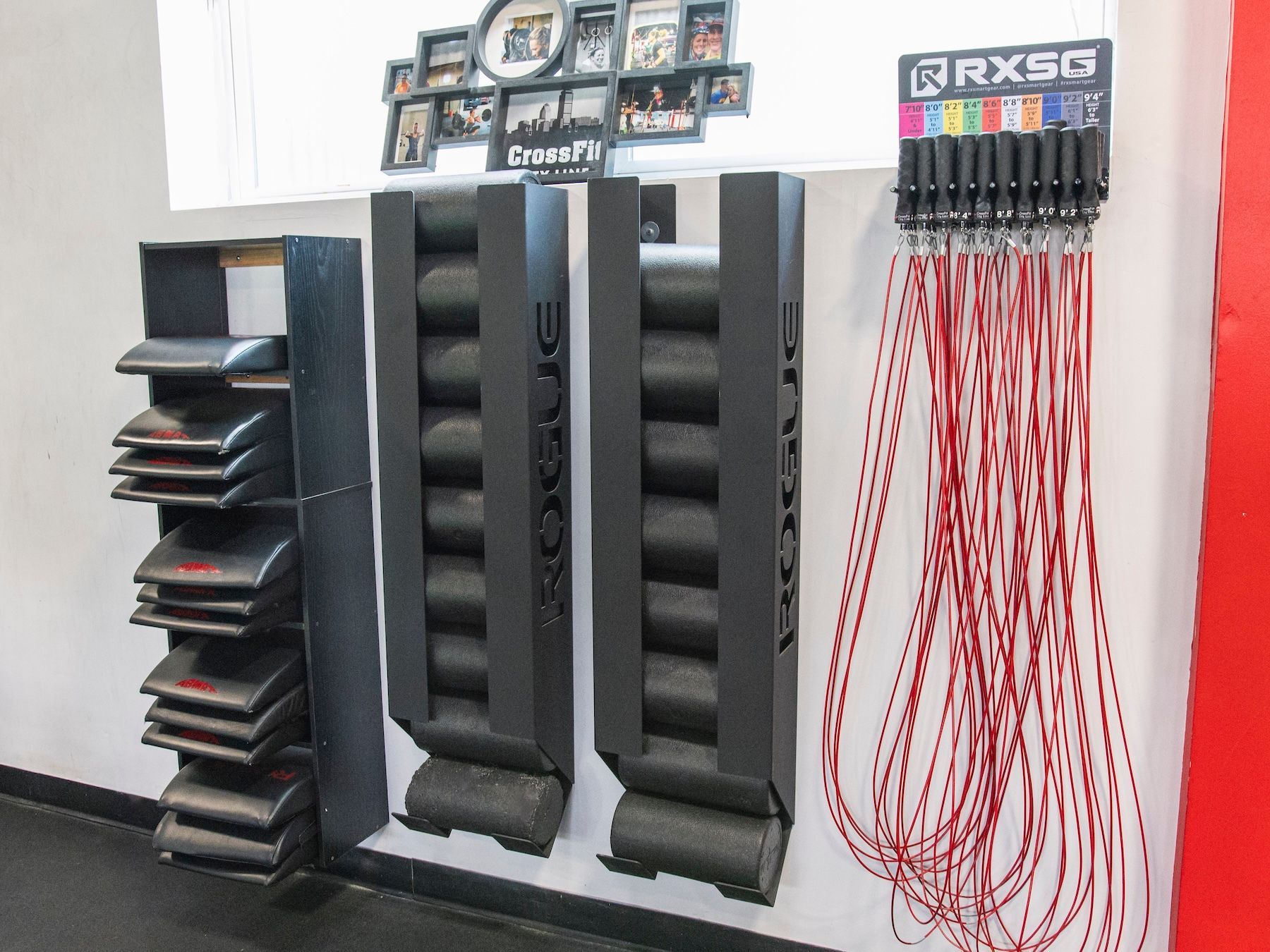 A wall with a bunch of ropes and a sign that says rxsg