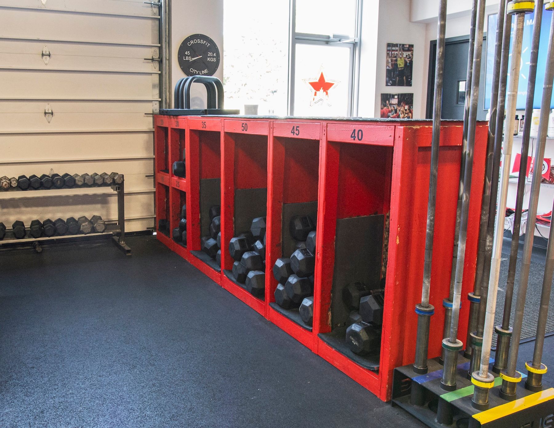 A gym with a lot of dumbbells and barbells