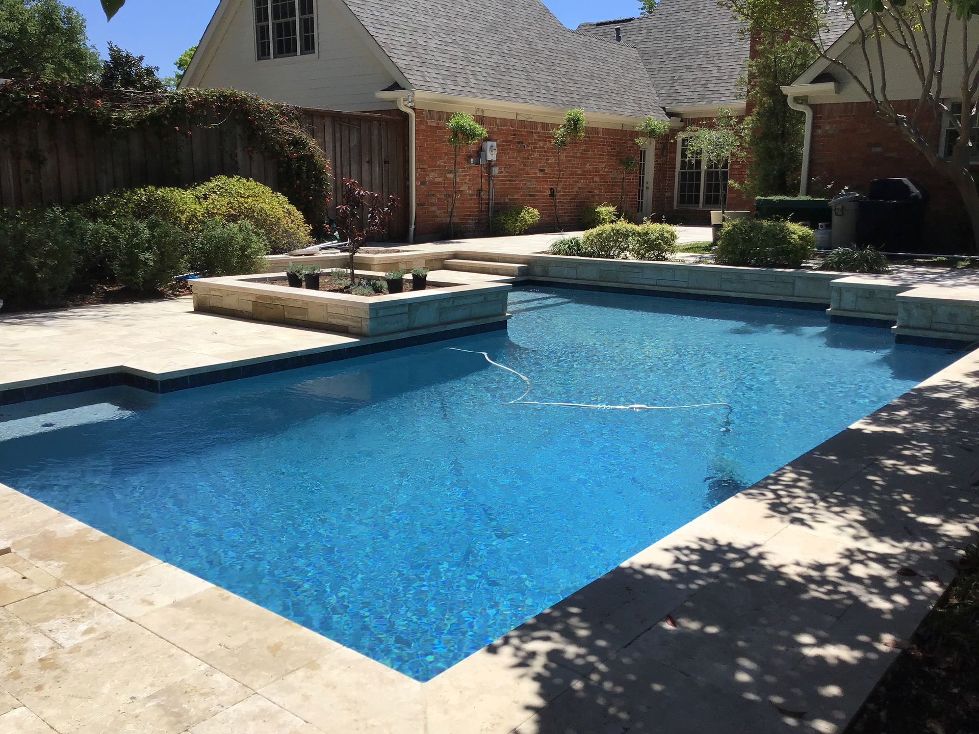 A large swimming pool in the backyard of a house