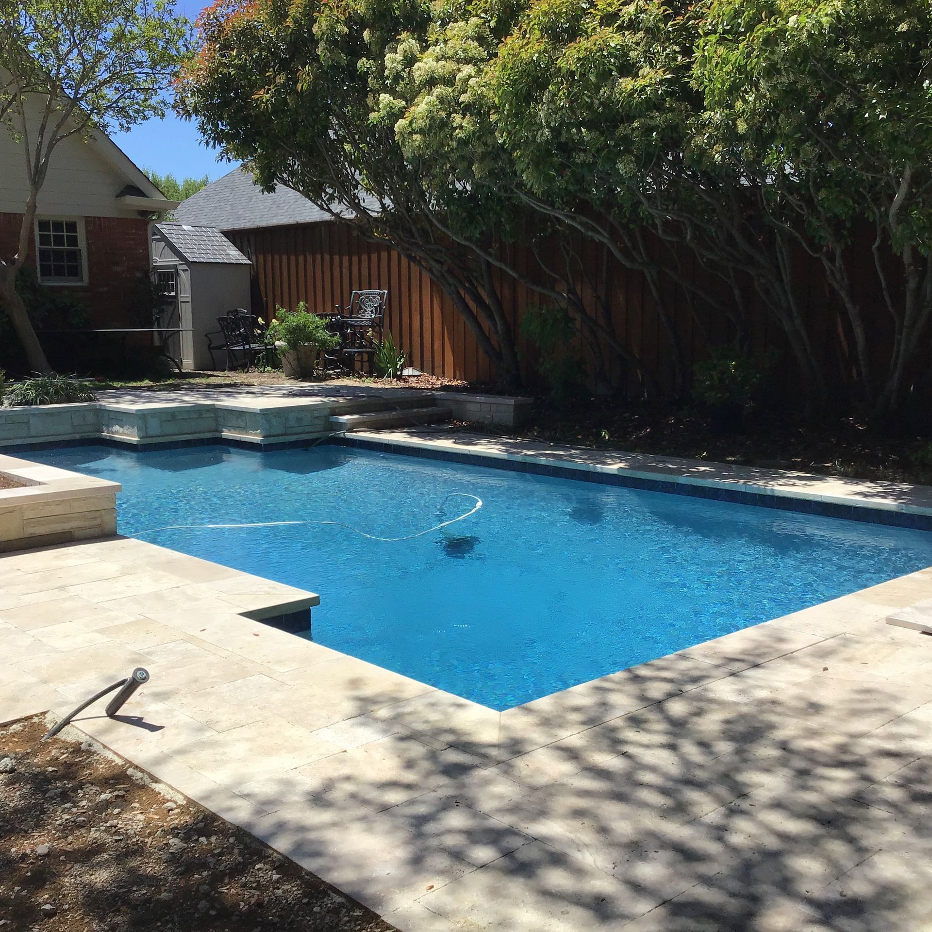 A large swimming pool in the backyard of a house
