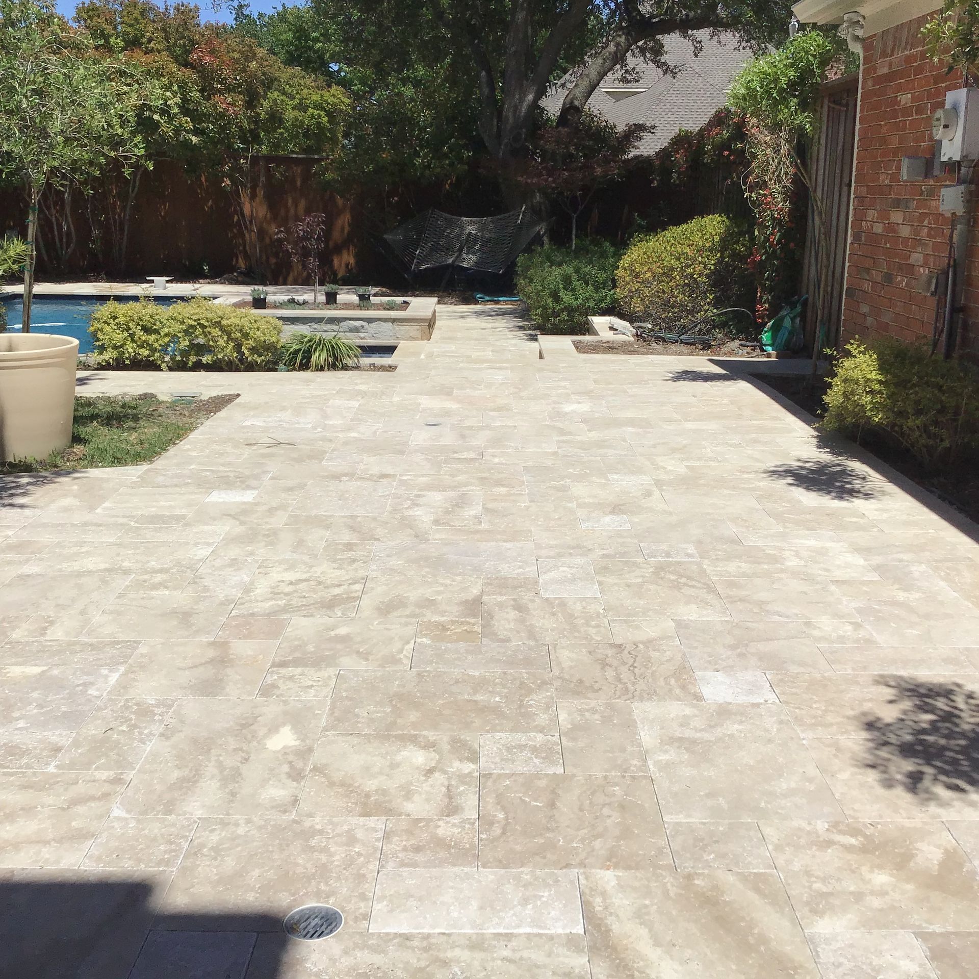 A walkway leading to a pool and a house
