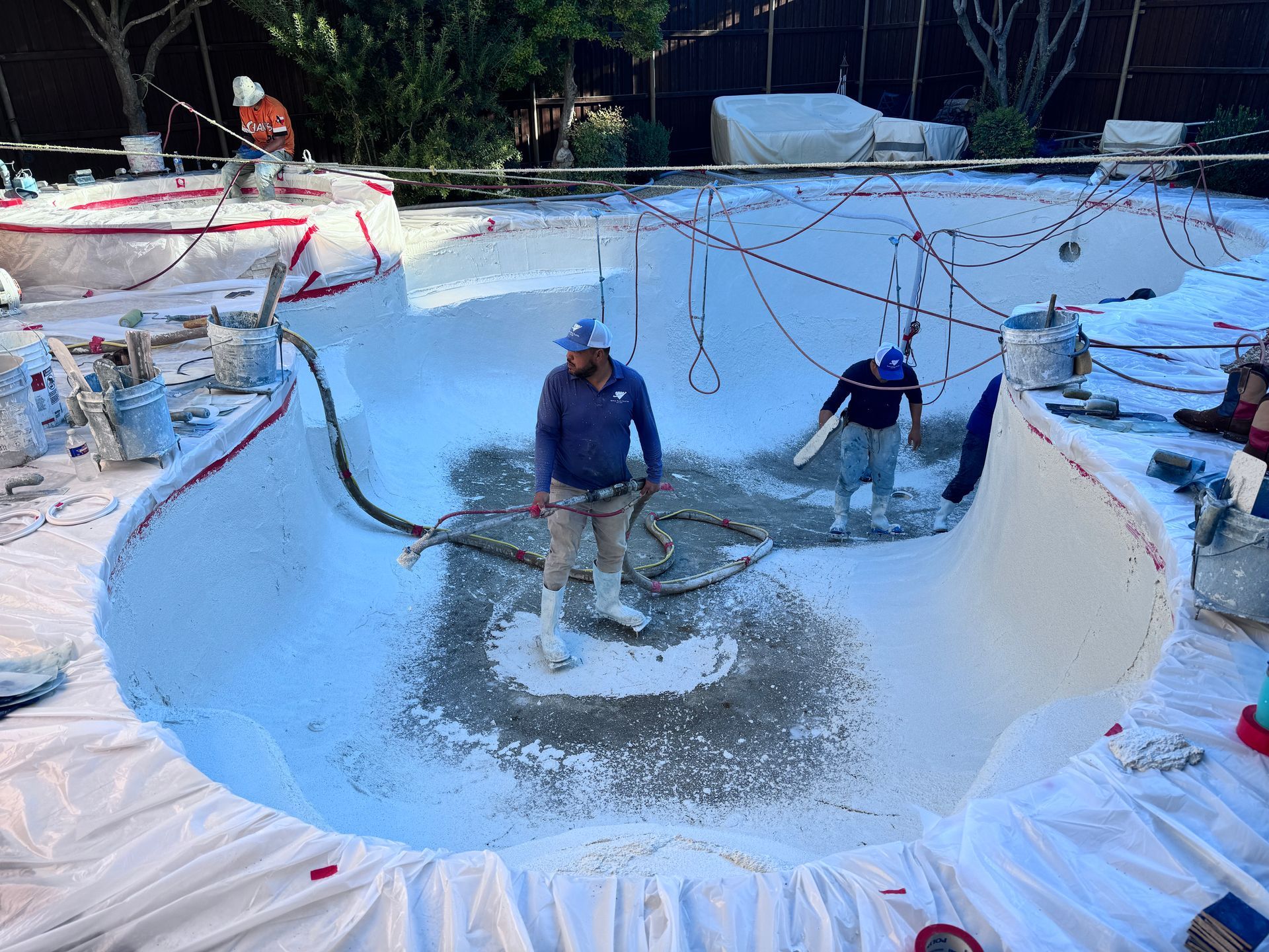 A group of people are working on a swimming pool.