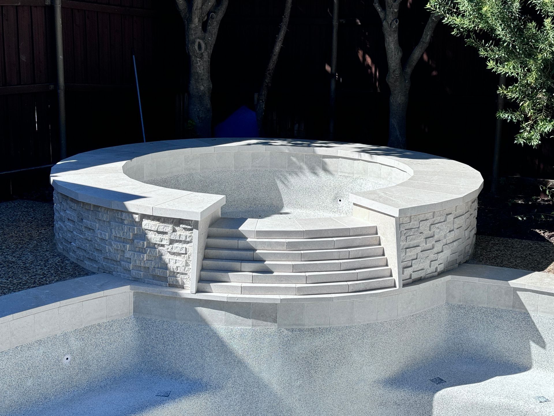 A swimming pool with stairs leading up to it