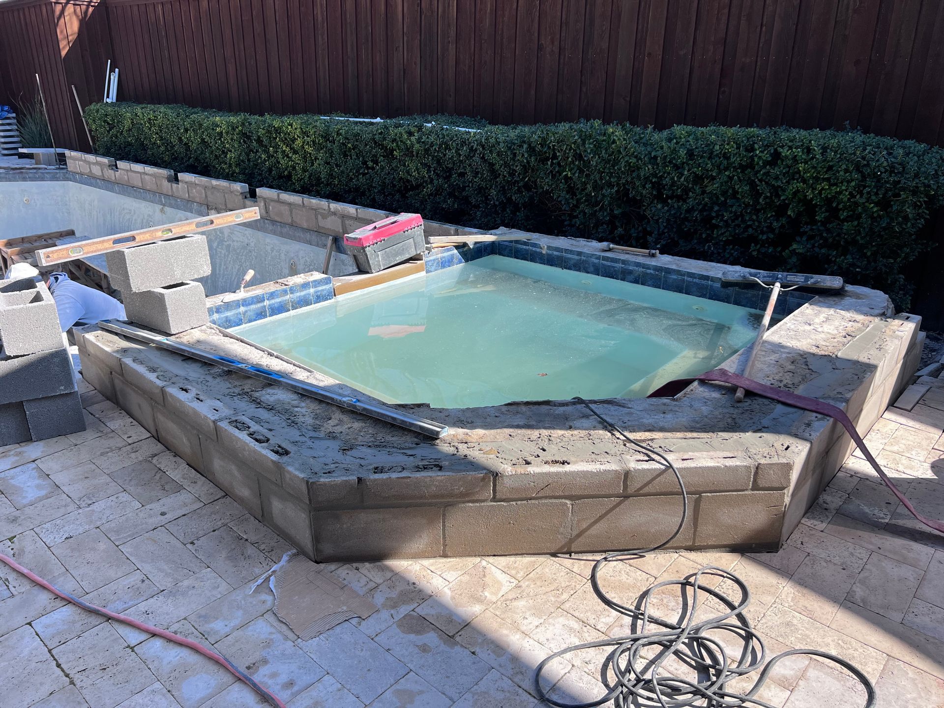 A swimming pool is being built in a backyard.