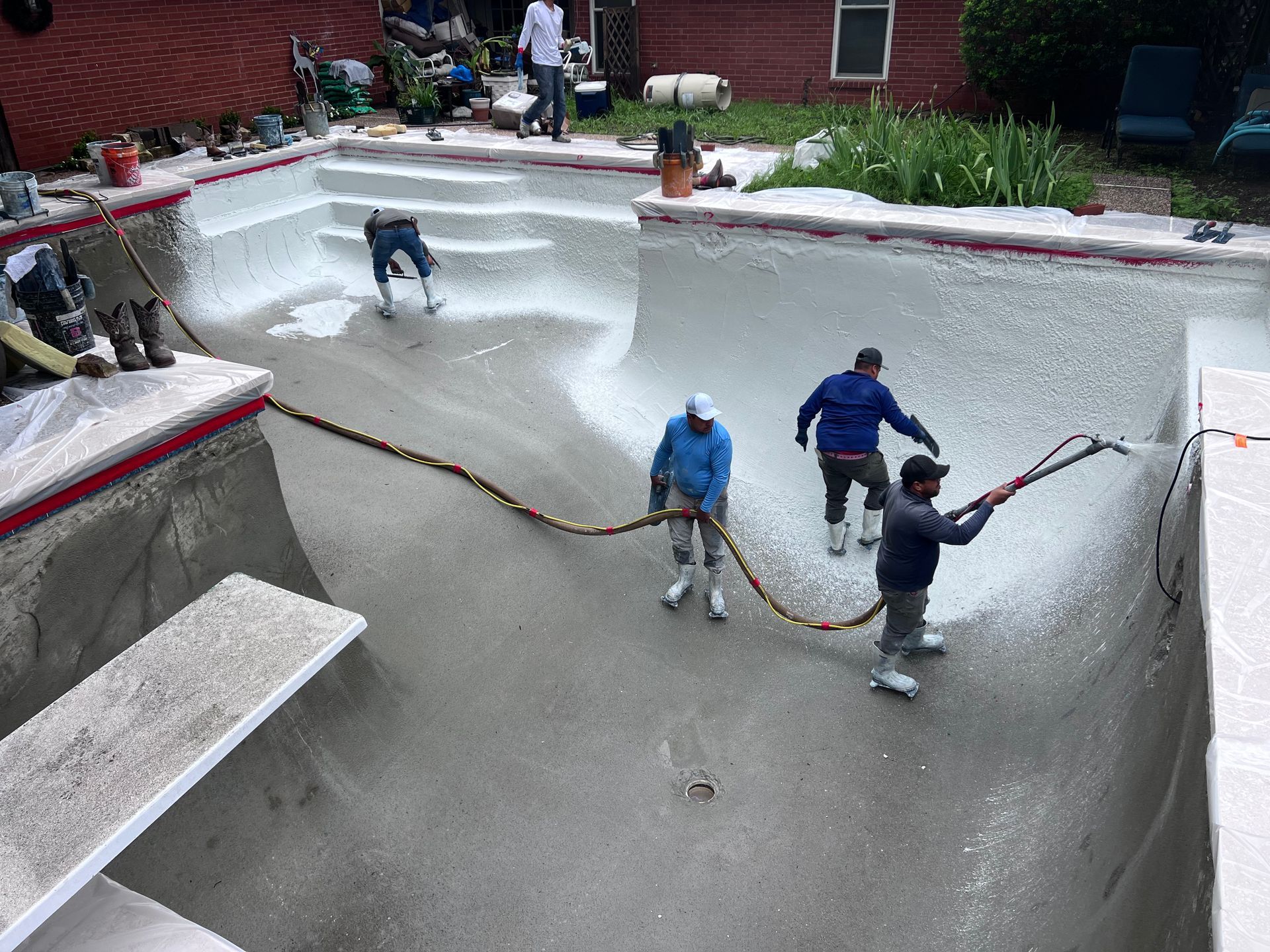 A group of people are working on a swimming pool.