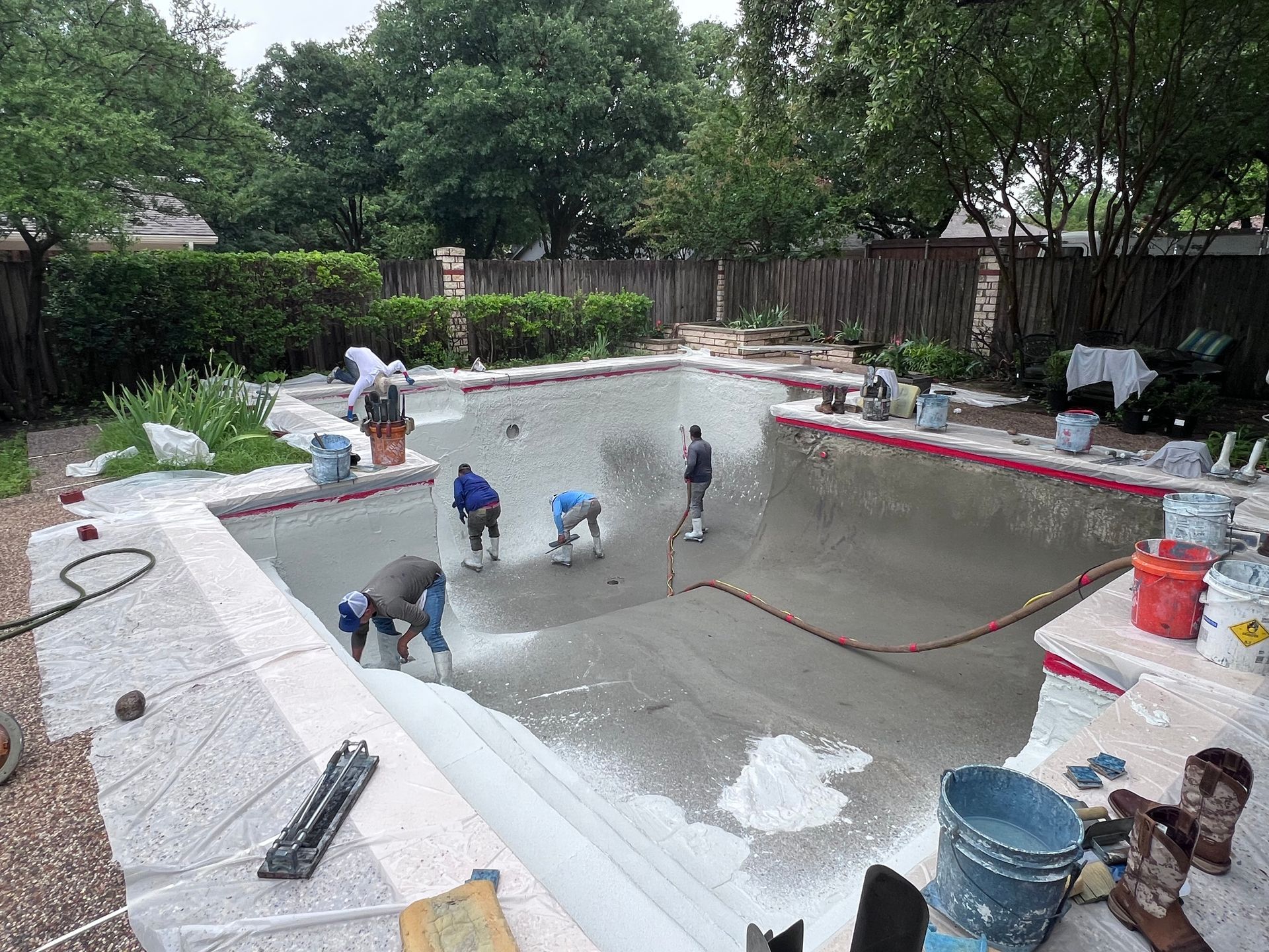 A group of people are working on a swimming pool.