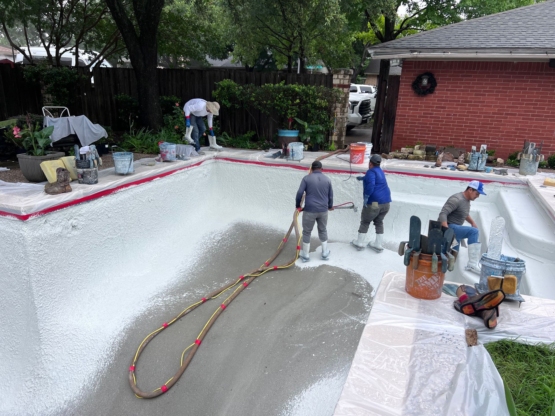A group of people are working on a swimming pool.