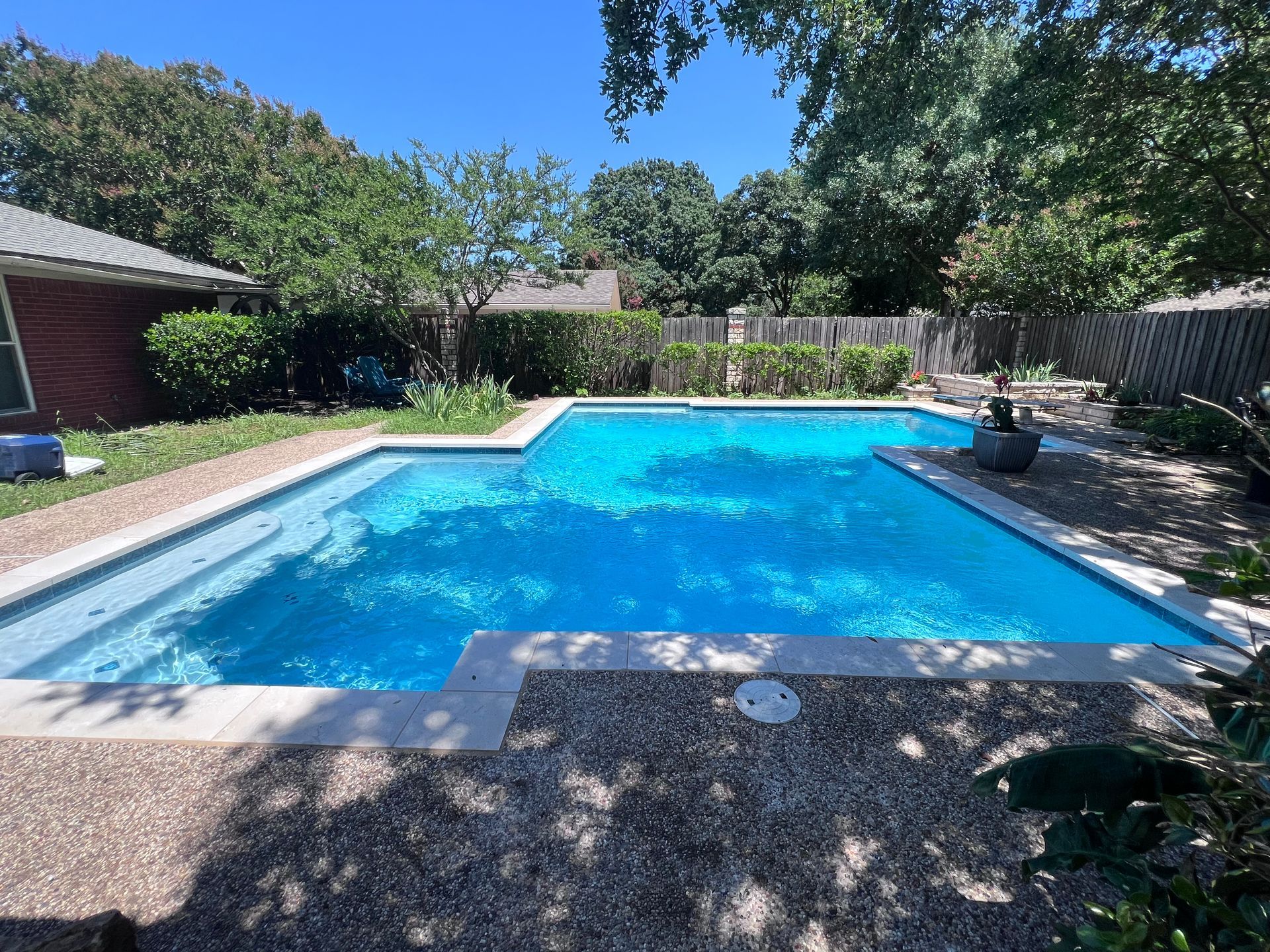 A large swimming pool in the backyard of a house