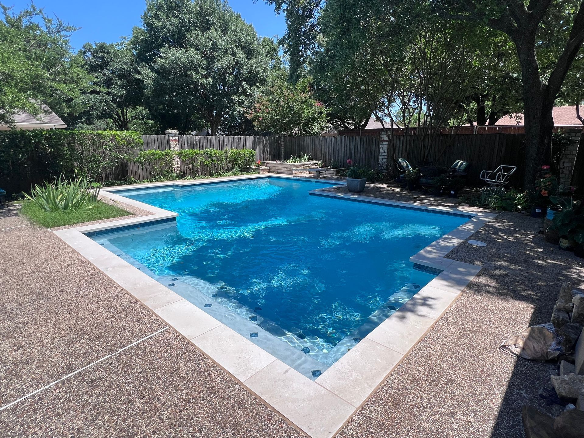 A large swimming pool in the backyard of a house