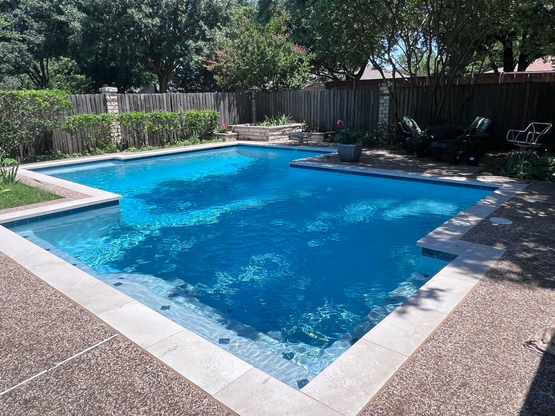 A large swimming pool in the backyard of a house