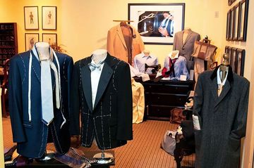 A room filled with mannequins wearing suits and ties
