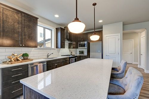 A kitchen with stainless steel appliances and granite counter tops.