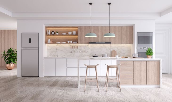 Modern white kitchen with wood accents, island seating, pendant lights, and stainless steel fridge Modern white kitchen with wood accents, island seating, pendant lights, and stainless steel fridge