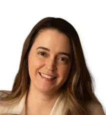 Woman with long brown hair, smiling, wearing a light-colored top, against a white background.