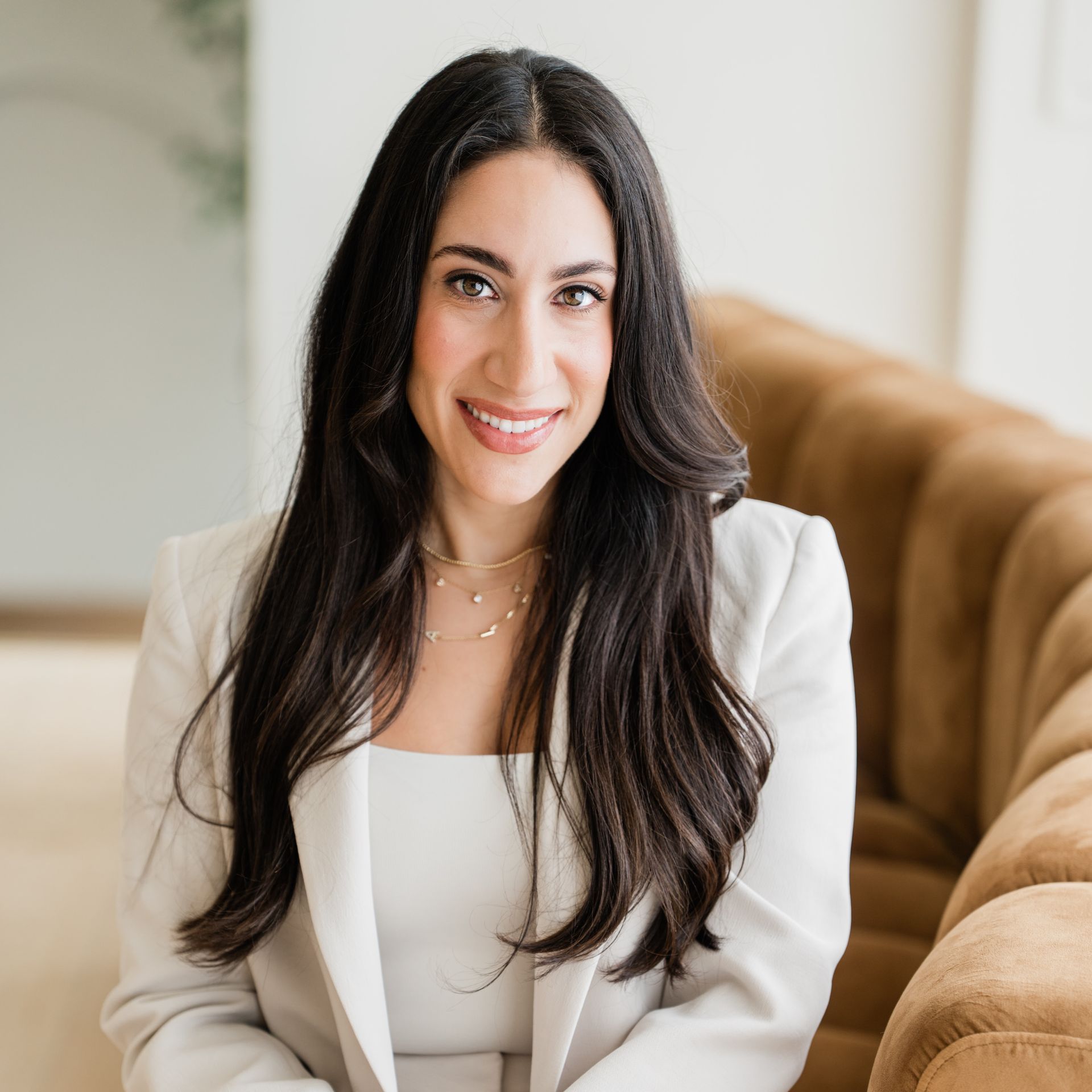 A woman wearing a white jacket with the name dr. on it