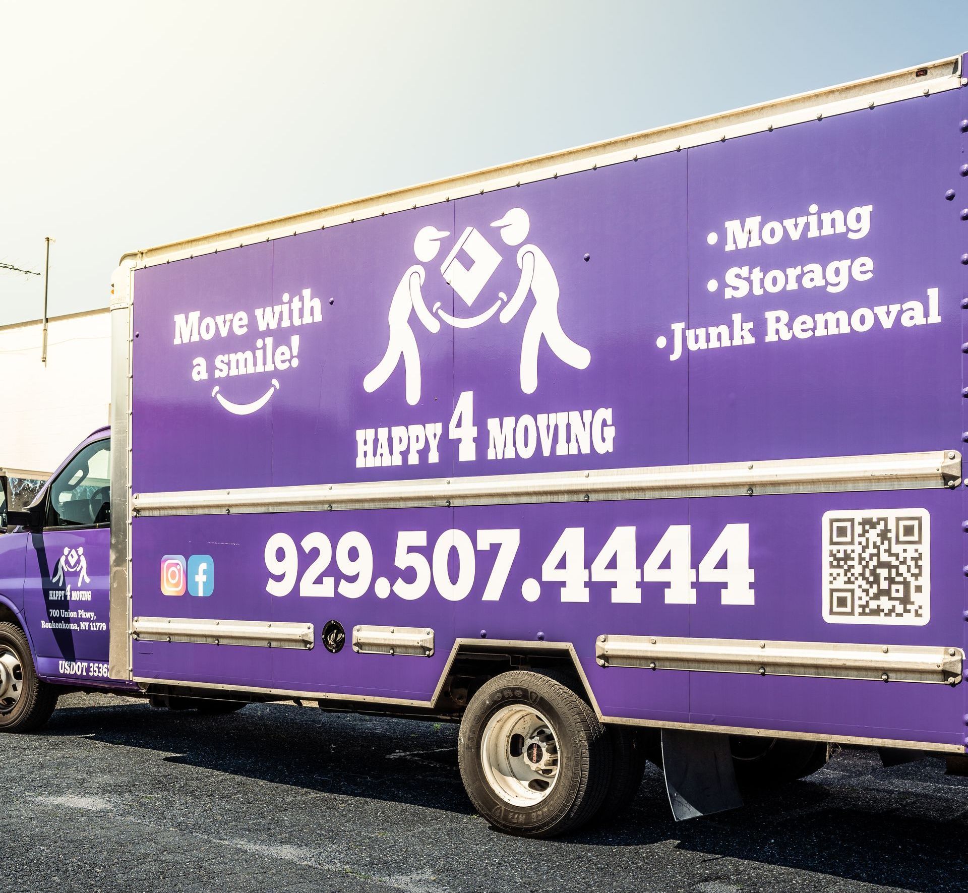 A moving truck is parked on the side of the road.