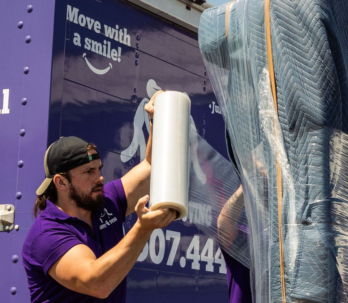 a men is wrapping a moving blanket