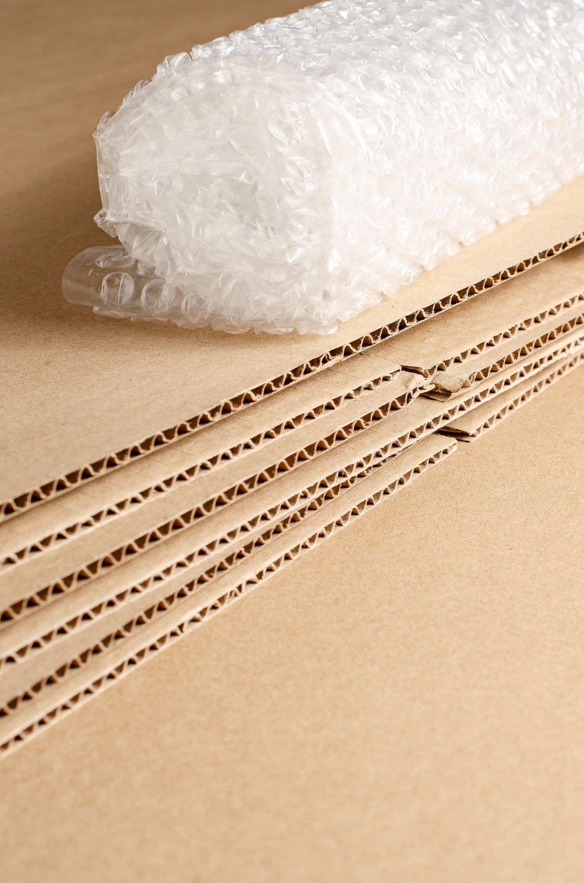 A roll of bubble wrap is sitting on top of a cardboard box.