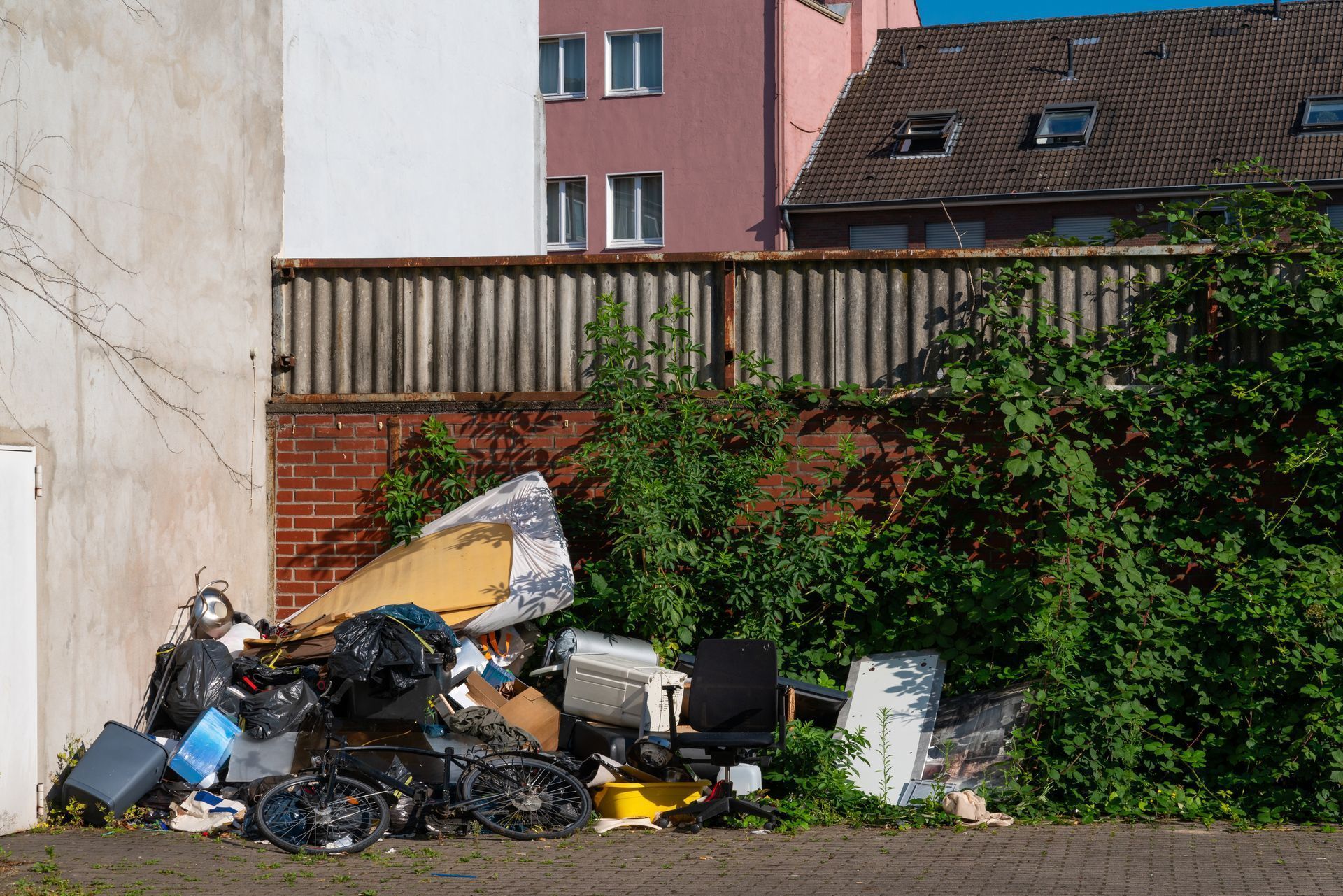 A pile of trash is sitting in front of a building.
