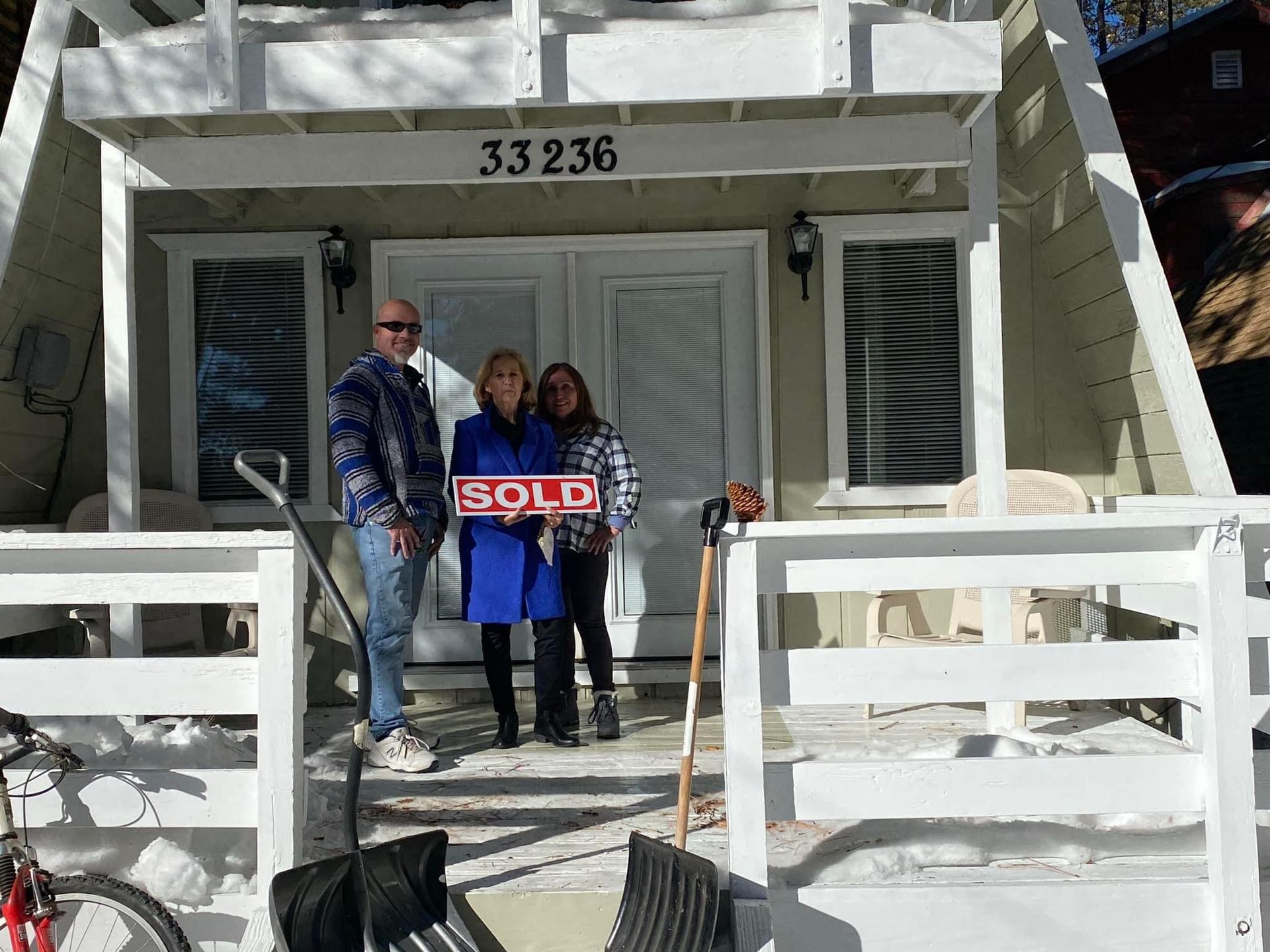 A patio with a lot of furniture and lights at night.