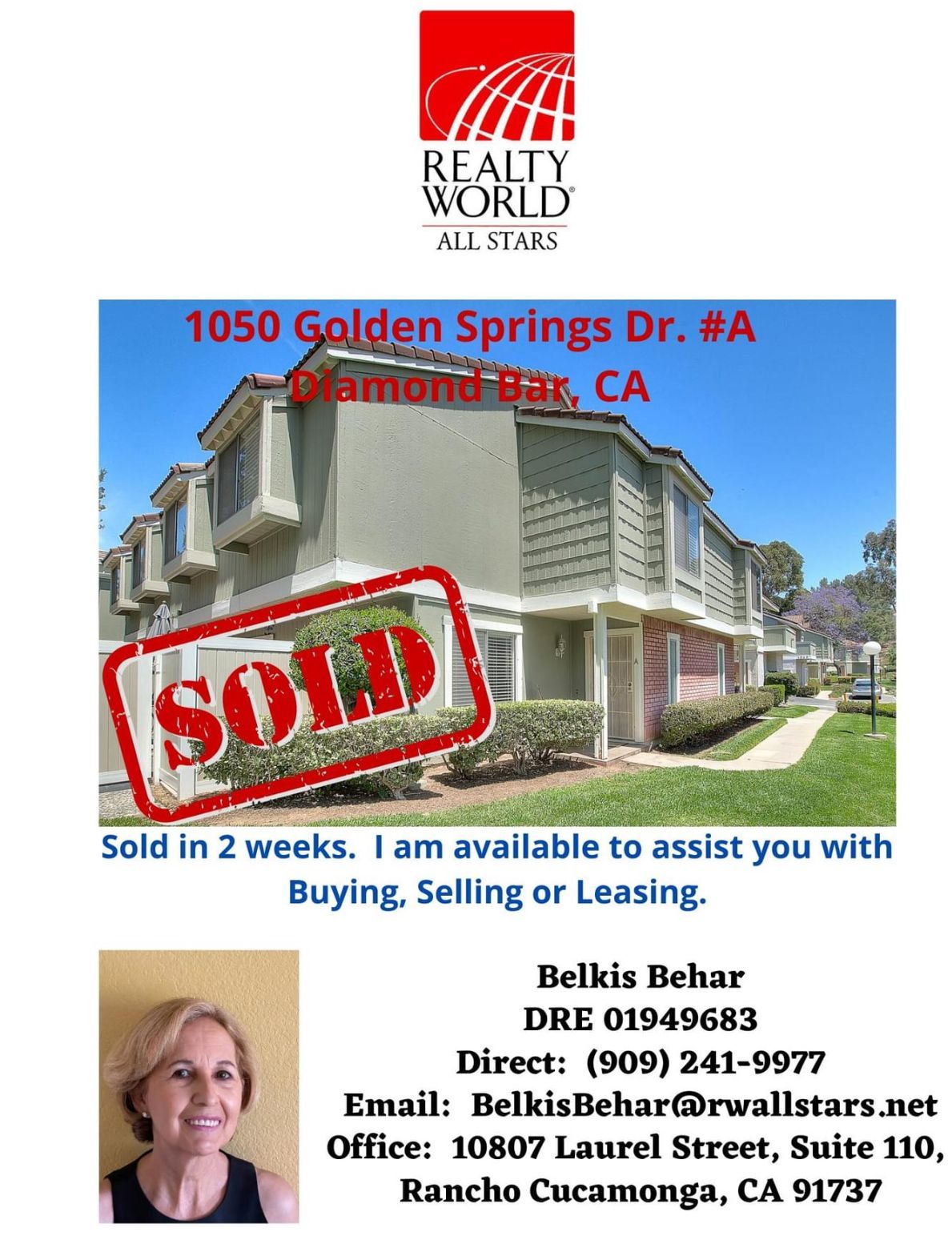 A living room with a couch , chairs , ottoman and a mirror