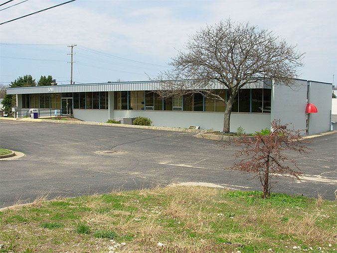 A large building with a tree in front of it