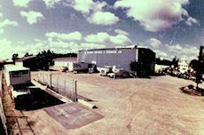 A large building with a lot of cars parked in front of it.