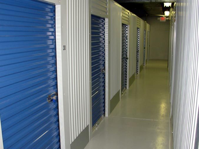 A hallway with blue doors and the number 31 on the wall